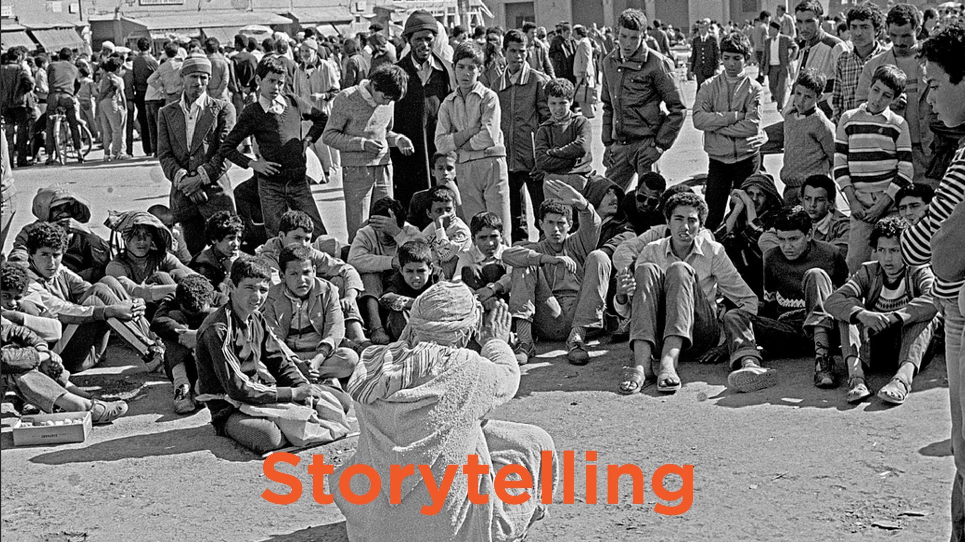 storyteller holding court in middle east to circle of young people